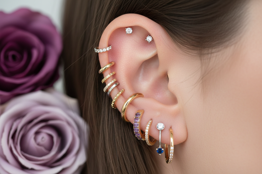 Curated ear stack featuring cartilage hoops, studs, and clicker earrings in helix, tragus, and conch piercings